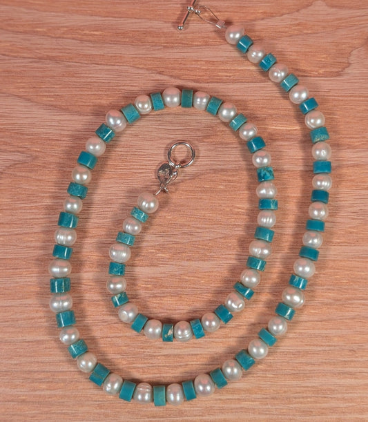 Necklace with blue and white beads on a wooden surface